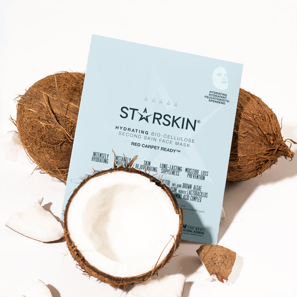 Atmospheric image of the STARSKIN Red Carpet Ready sheet face mask and three coconuts