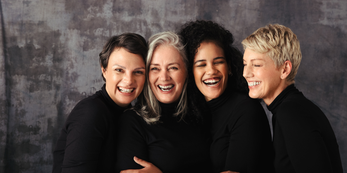 Women of different ages loughing while being dressed in black swaters