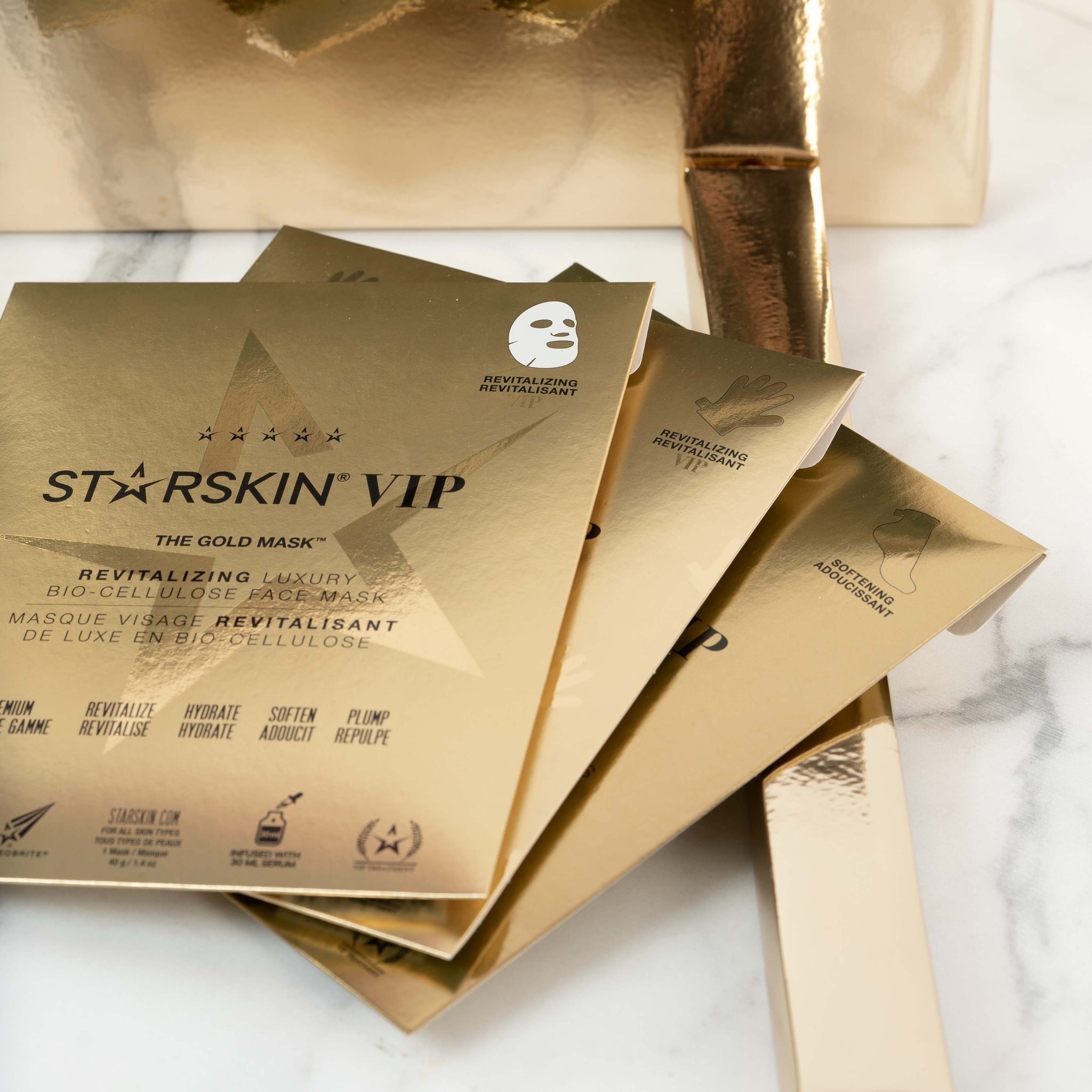The whole Starskin gold product line up being displayed on a marble background.