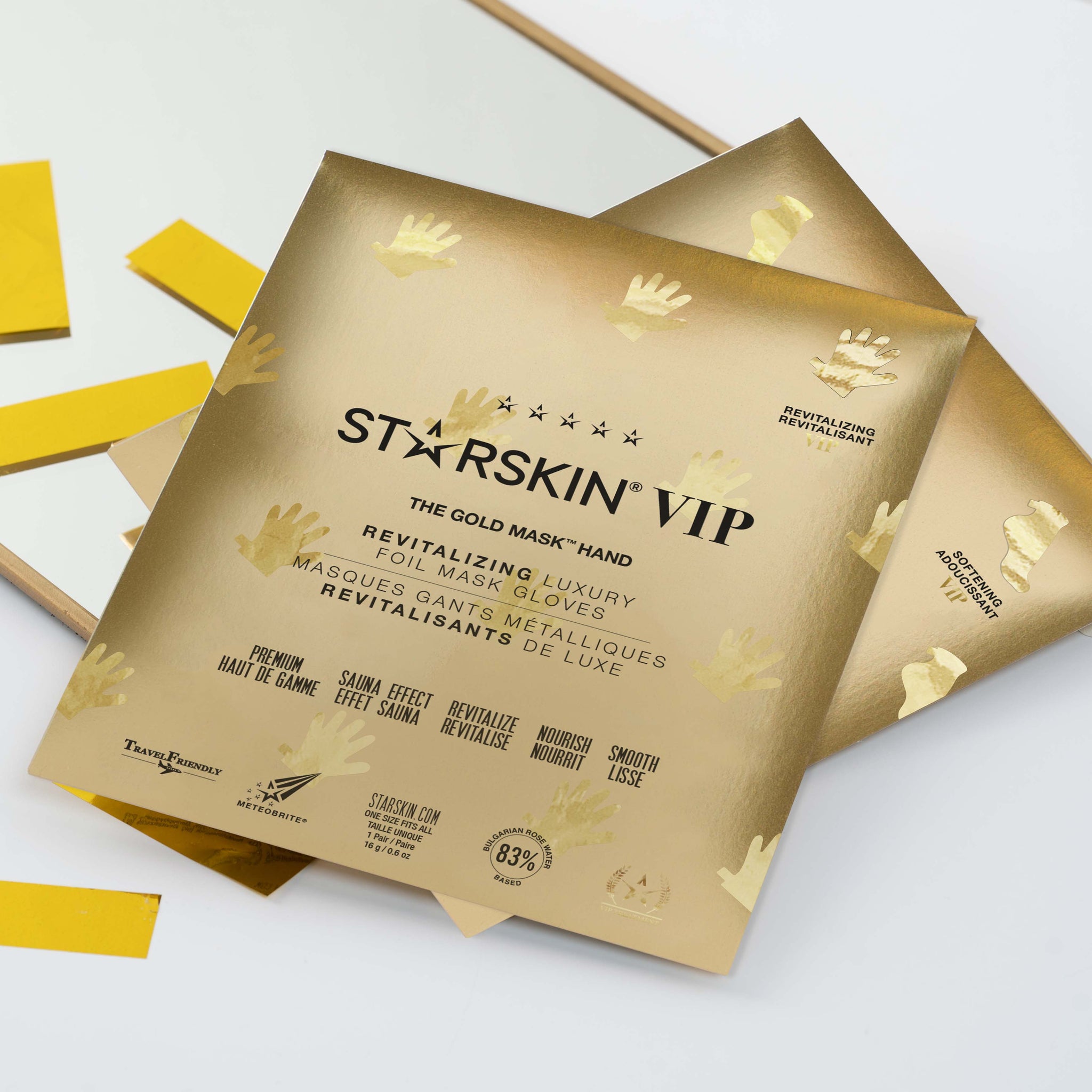 Starskin Gold Mask - Hand product packaging in the middle of the image. It's on top of a small mirror and the background of the image is white.