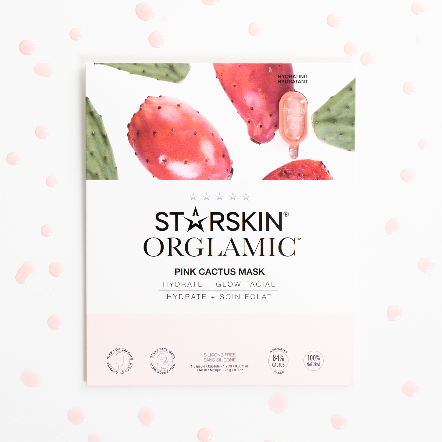 The Pink Cactus Oil Mask product packaging in the middle on a white background. Around the product are drops of the prickly pear oil.