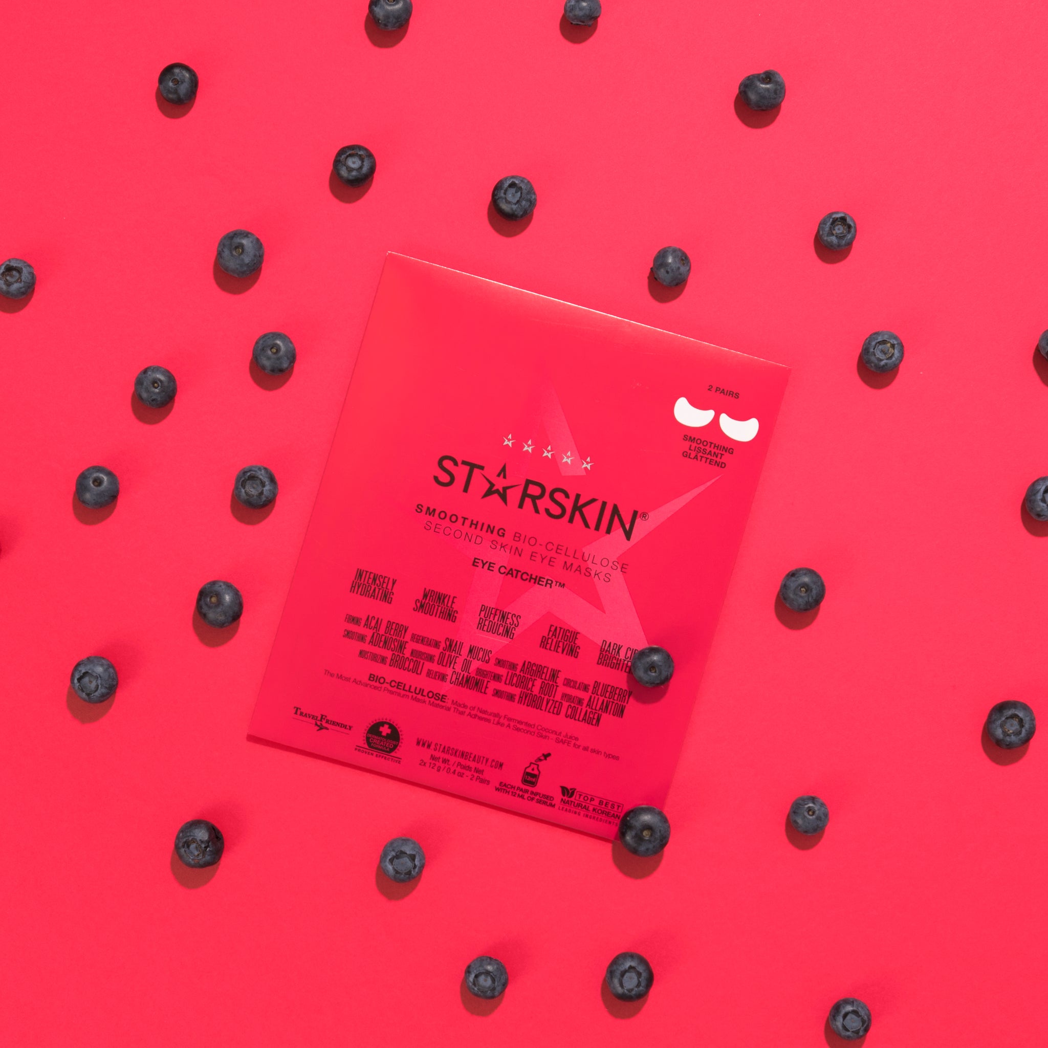 Starskin's eye catcher in the middle with blueberries around the product on a bright pink background. 