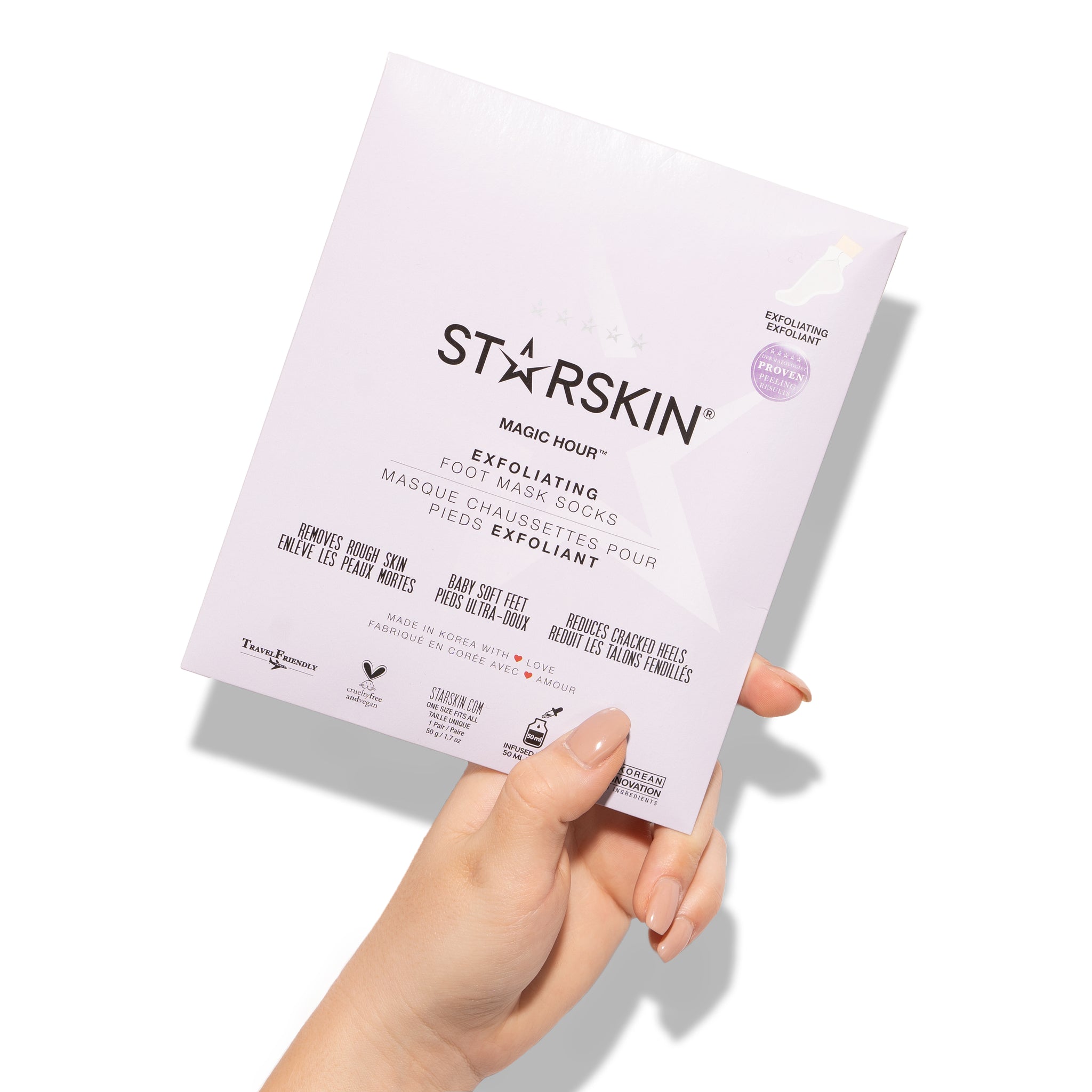 Product packaging of starskin's magic hour foot mask is being held in a persons hand.