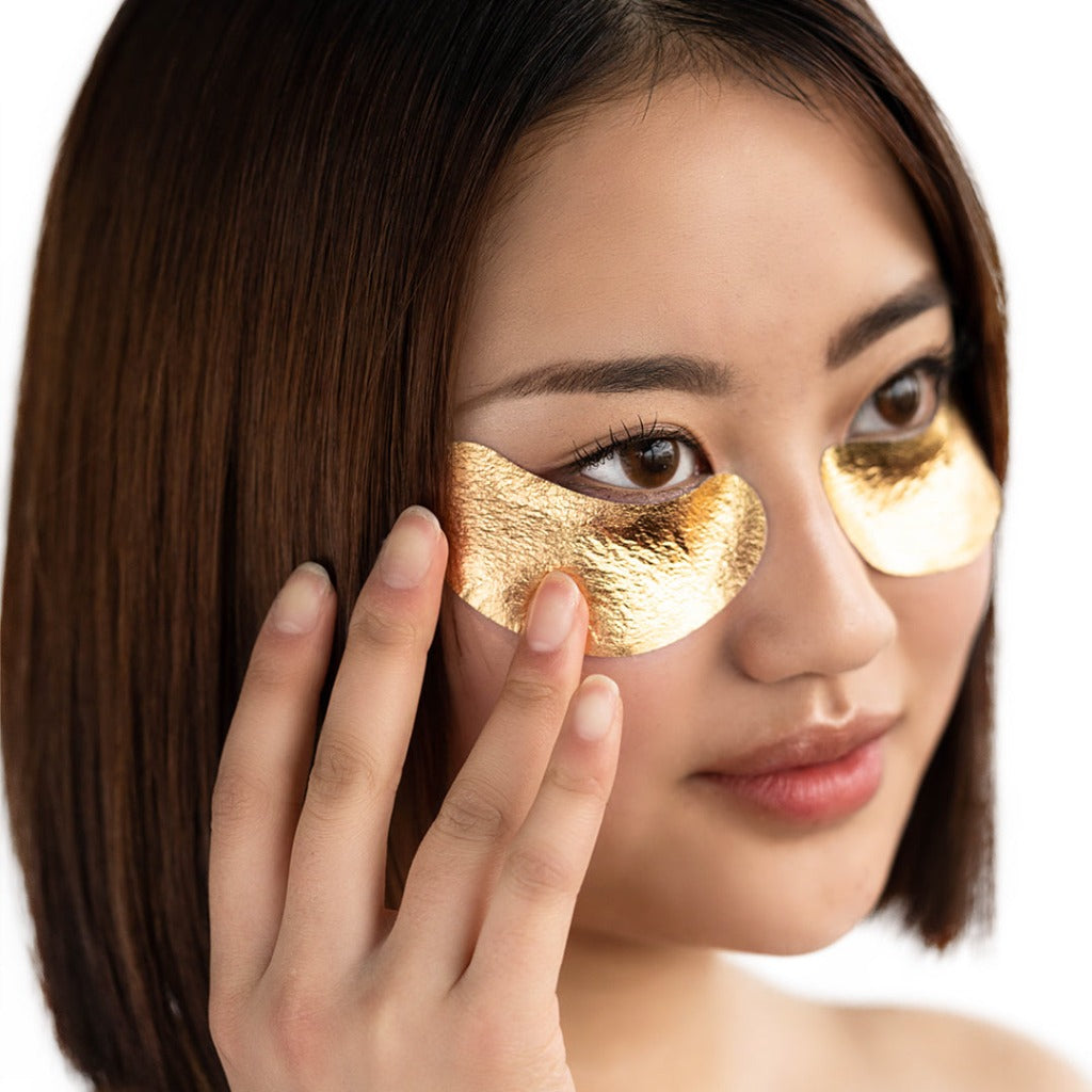Model wearing Starskin VIP The Gold Mask Eye under her eyes