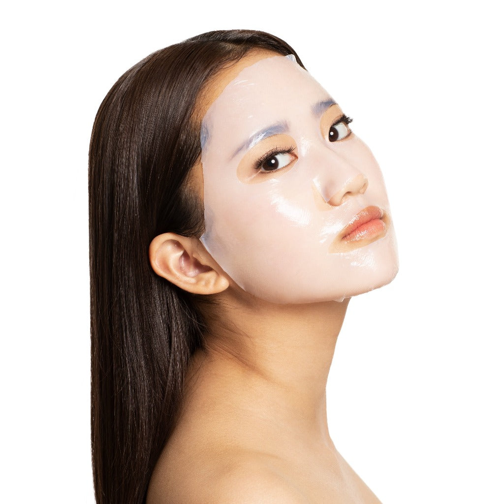 Side view of a model wearing the STARSKIN Close-up face sheet mask on her face
