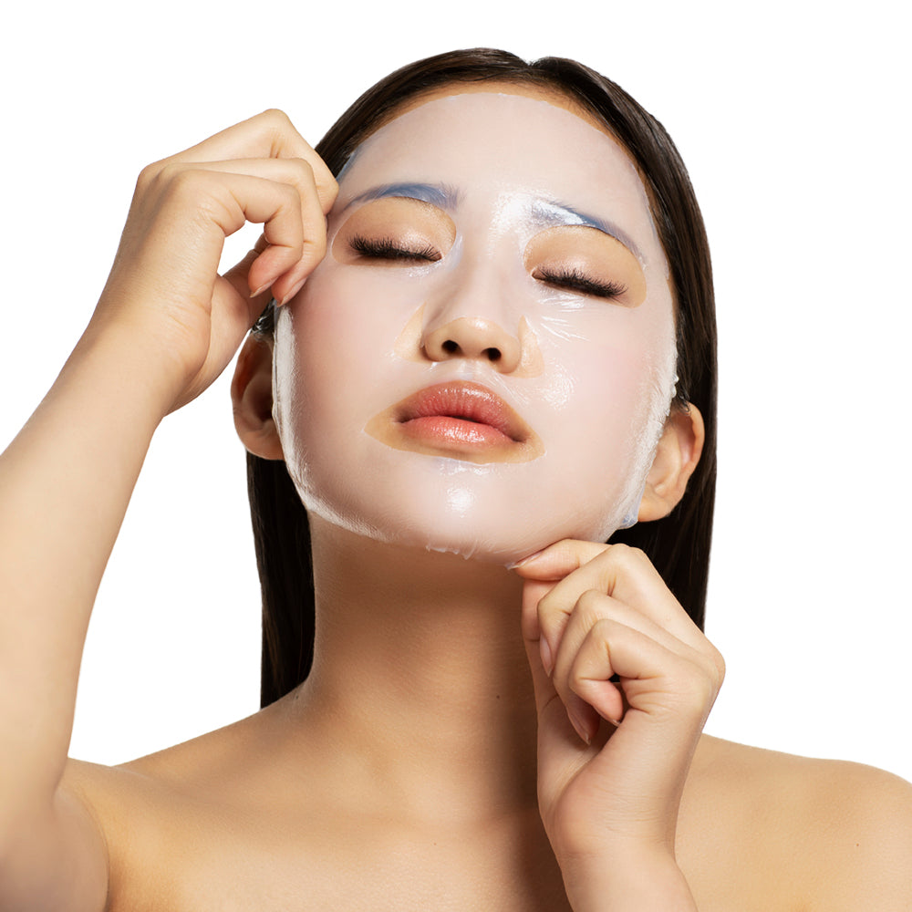 Model wearing Starskin VIP The Gold Mask Bio-cellulose face mask