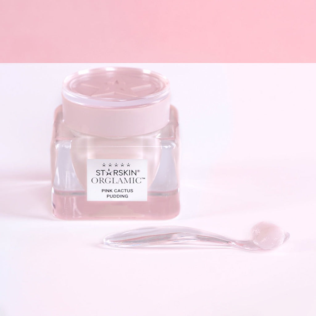 Atmospheric image of the STARSKIN ORGLAMIC Pink Cactus Pudding travel size with a little spoon in front of it