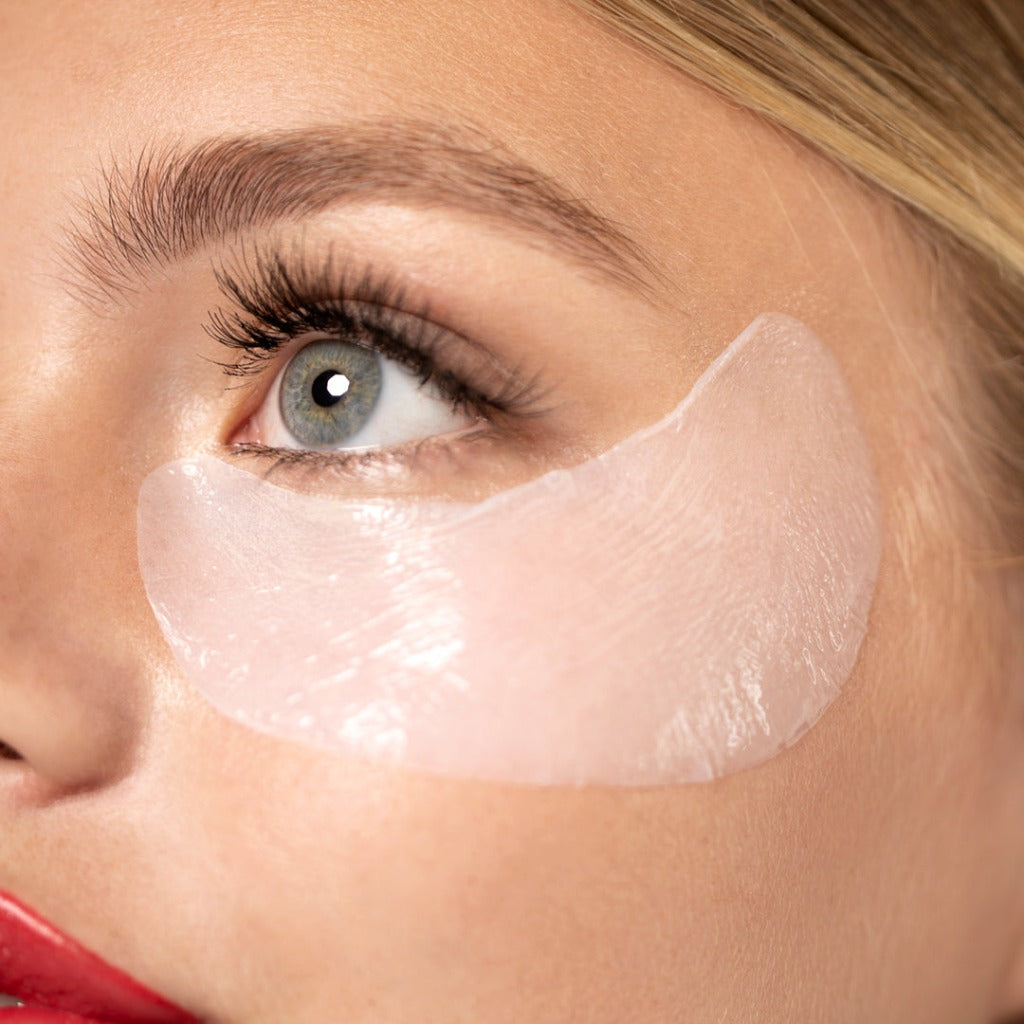 Close up of a model wearing the STARSKIN Eye Catcher eye mask and red lipstick