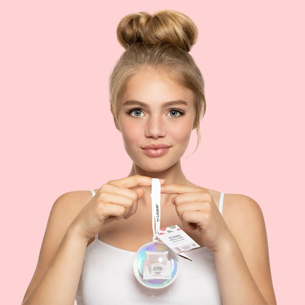 Image of a model holding the STARSKIN ORGLAMIC Pink Cactus mini Pudding Ornament
