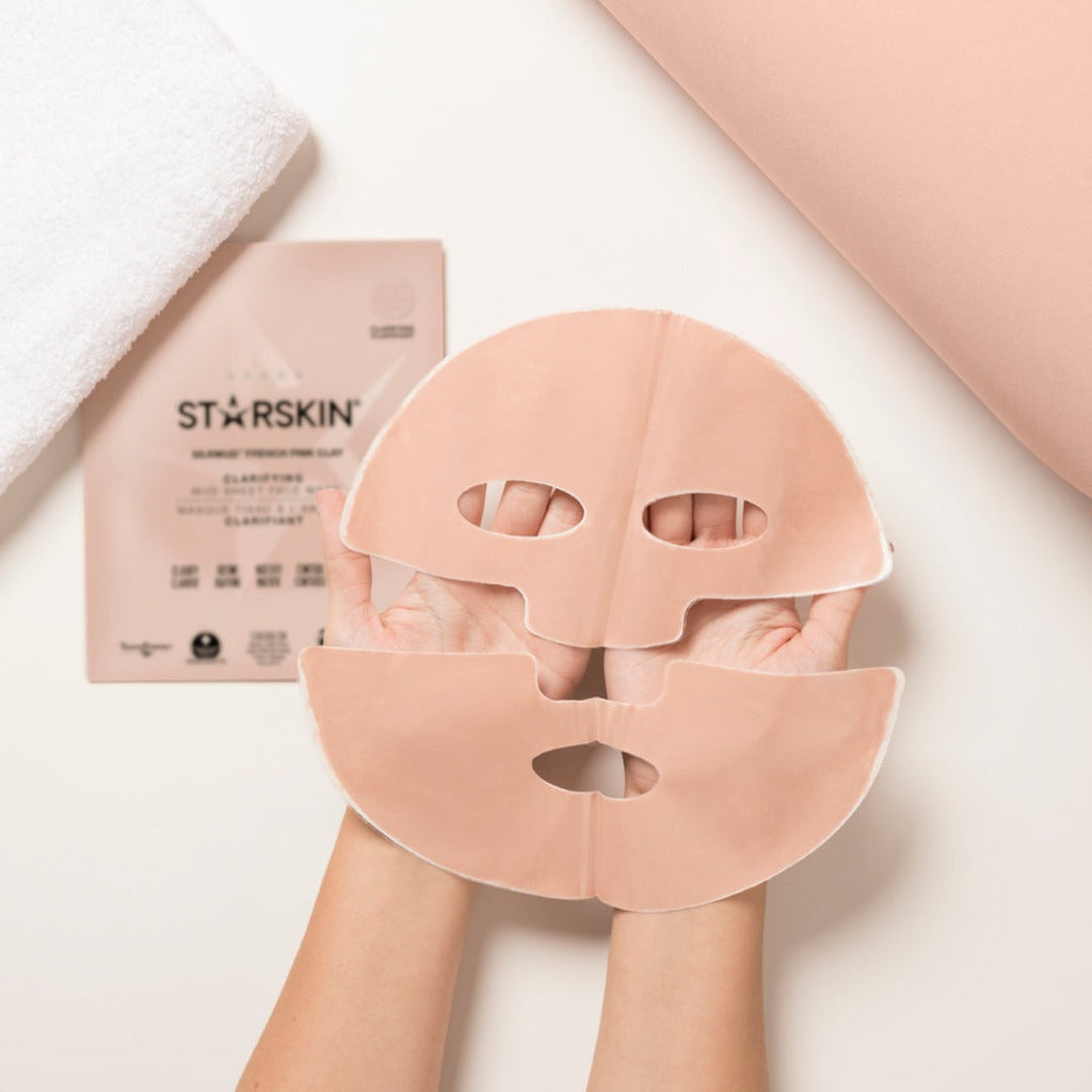 Atmospheric image of two hands holding the STARSKIN Silkmud French Pink Clay mask to show the upper and lower part of the mask