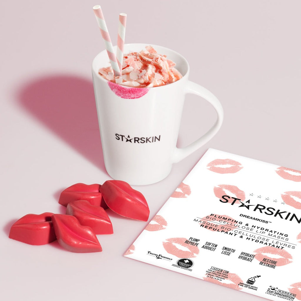 Atmospheric image of the STARSKIN Dreamkiss mask with a mug of hot chocolate and chocolate kisses around it